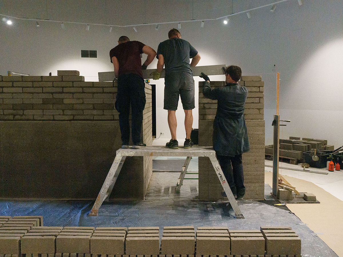 Inserting a structural concrete lintel spanning the opening of a door