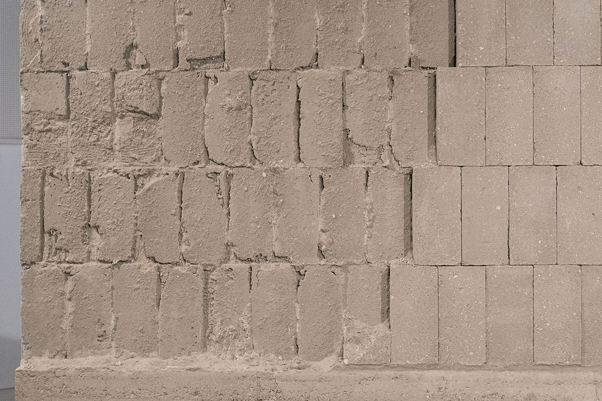 Dismantling of the exhibit, removing compressed earth tiles from the wall